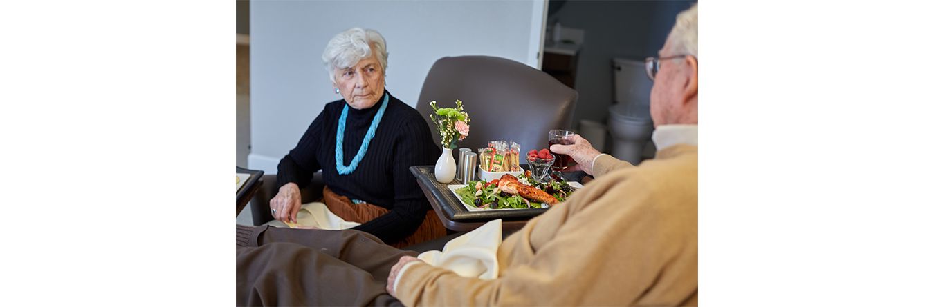 Senior Couple Living Community discussing covid-19