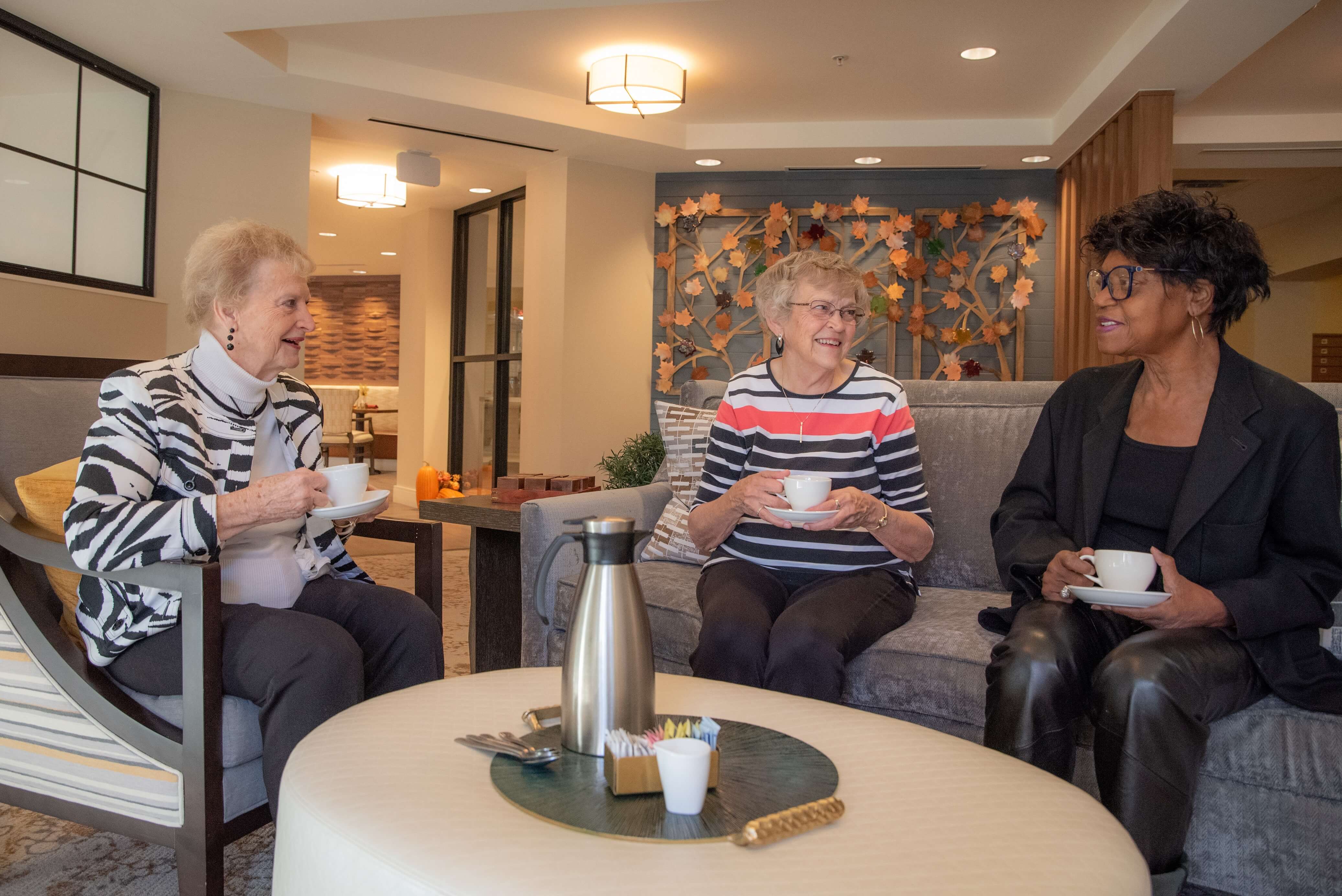 Clermont Park residents enjoying coffee in newly renovated living room